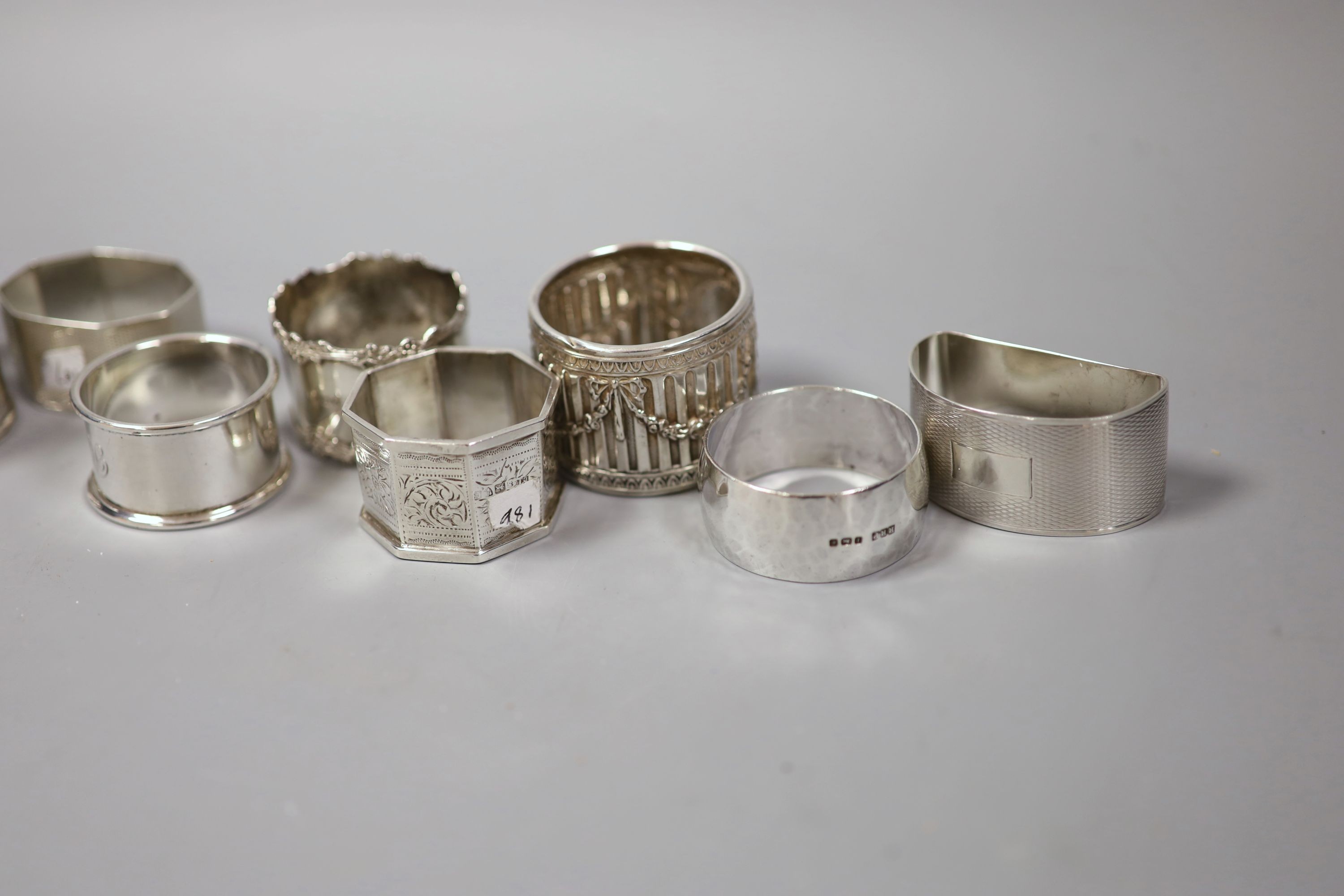 Nine assorted silver napkin rings, 7oz.